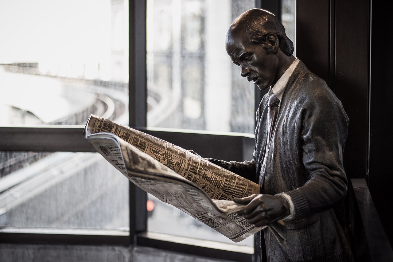 Statue Reading a Newspaper