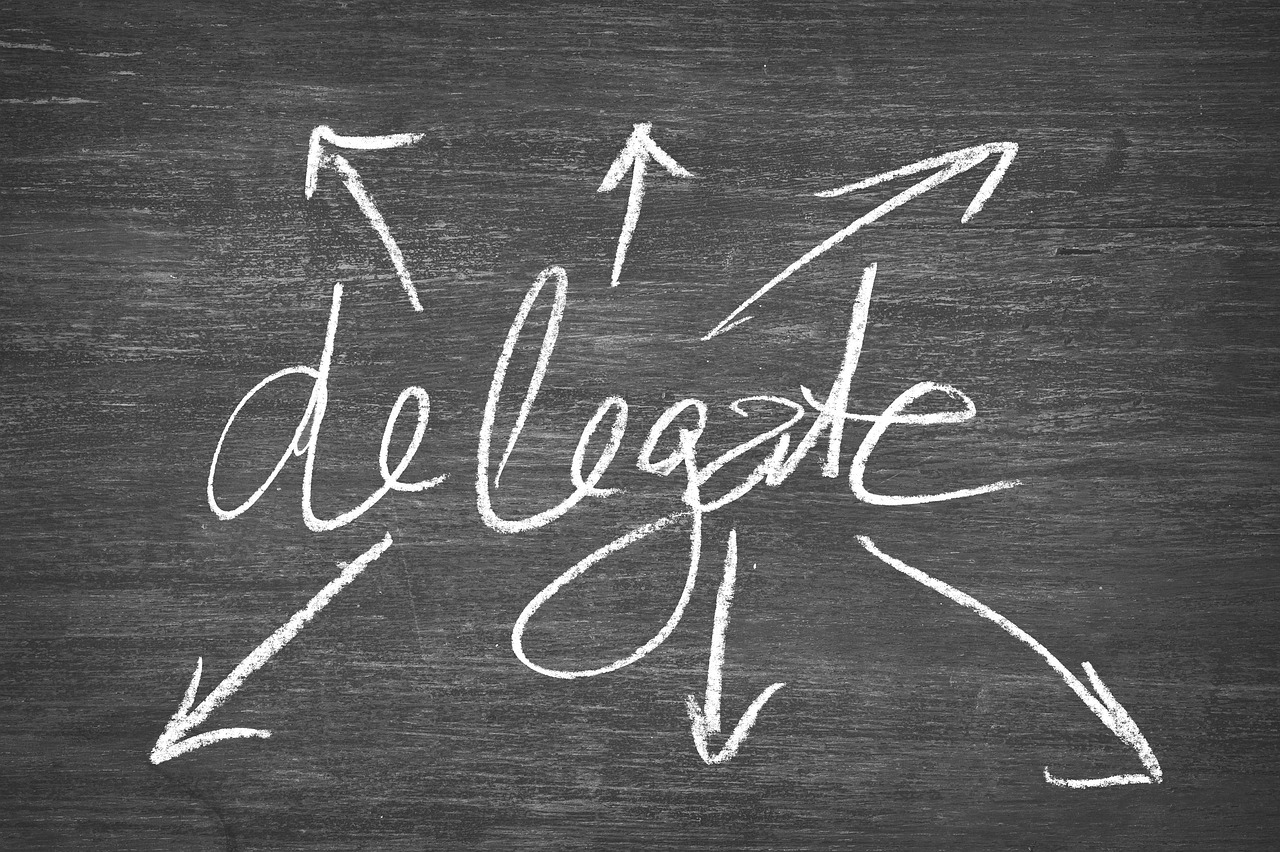 The word Delegate written behind a black background for The PR Chic Blog